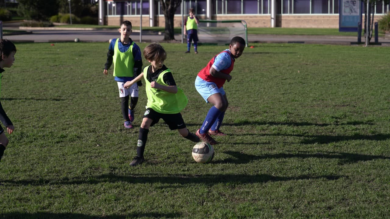 Mastery Football Academy coach engaging kids in a real soccer coaching session at Adelaide OSHC program