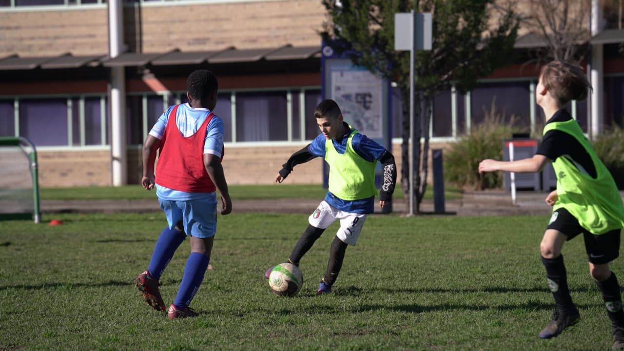 Kids having fun and getting active at a Mastery Football Academy OSHC soccer session in Adelaide